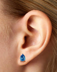 pear shape london blue topaz earrings on model ear