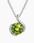 Silver necklace with a green peridot gemstone pendant on a white background