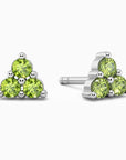 closeup image of trio peridot earrings in silver
