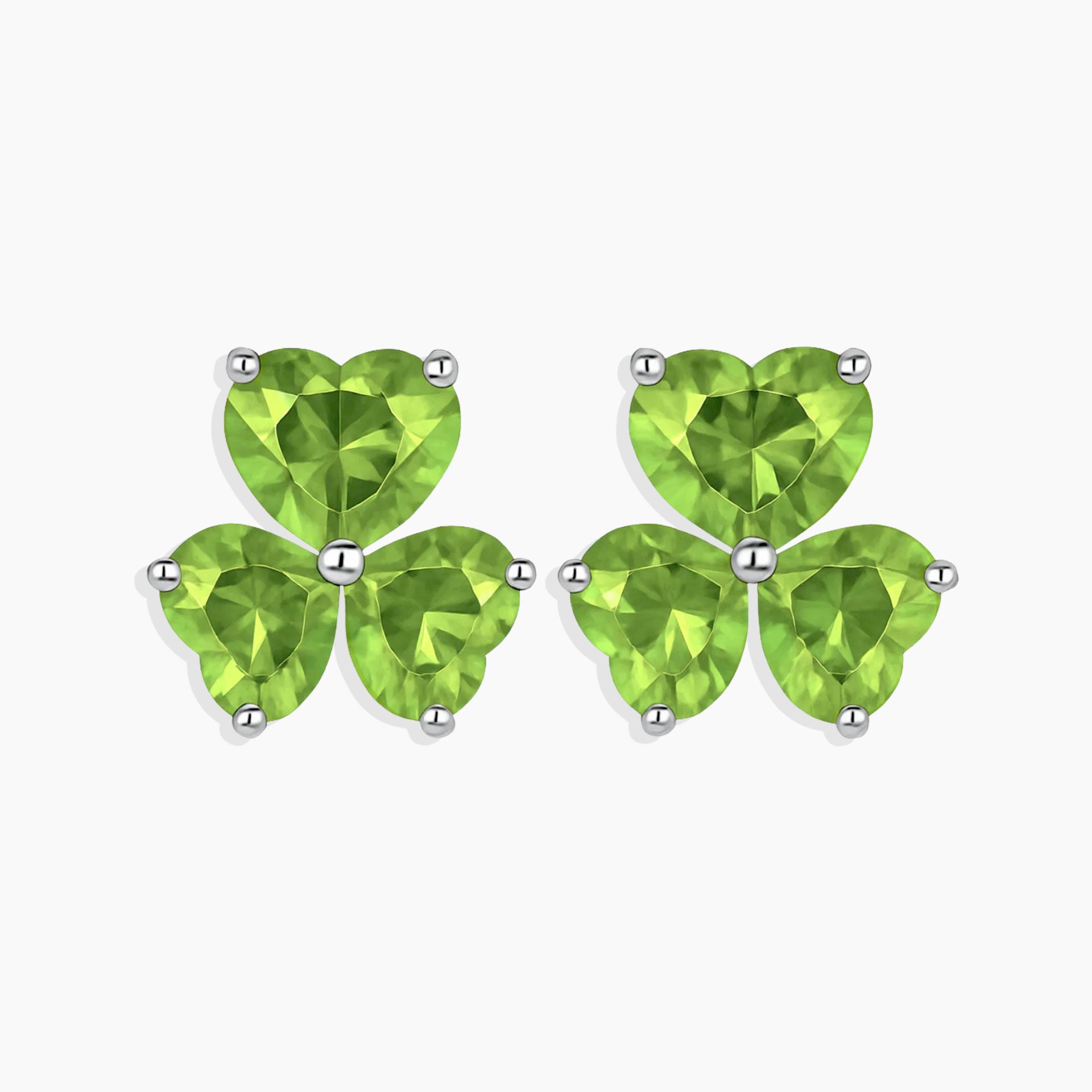 Pair of clover-shaped green gemstone earrings on a white background