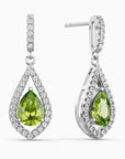Teardrop-shaped earrings with green peridot gemstones and diamond accents on a white background