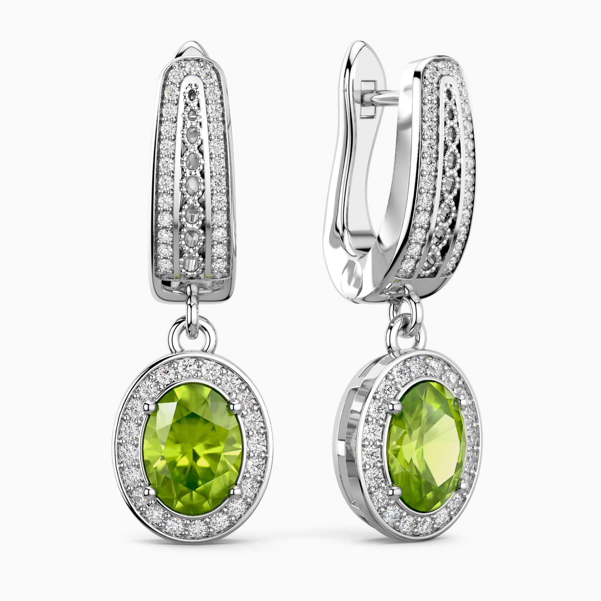 Pair of earrings with green gemstones and silver accents on a white background