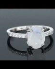 Rotating close-up video of the Irosk moonstone ring highlighting its gemstone glow and detailed side accents.