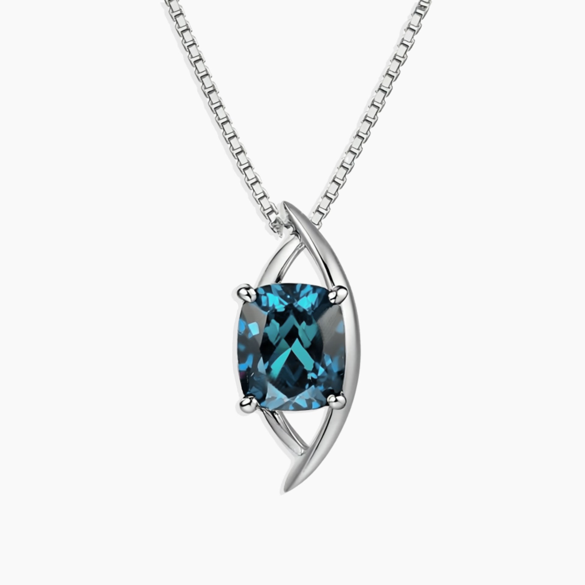 Luxury sterling silver pendant necklace featuring a cushion-cut London Blue Topaz in a sculptural globe-inspired setting with a box chain