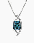 Luxury sterling silver pendant necklace featuring a cushion-cut London Blue Topaz in a sculptural globe-inspired setting with a box chain