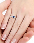 Round cut sapphire ring with halo CZ accents