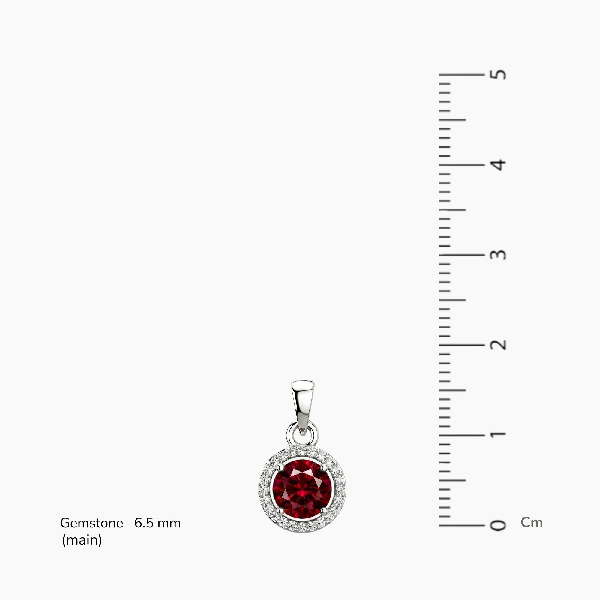 Silver pendant with a red round halo  ruby gemstone next to a ruler on a white background