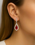 pear shape ruby dangling earrings on model ear