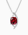 Sterling silver globe-style pendant necklace with cushion-cut created ruby in a bold red hue, set on a fine box chain.