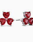 Red heart-shaped stud earrings on a white background