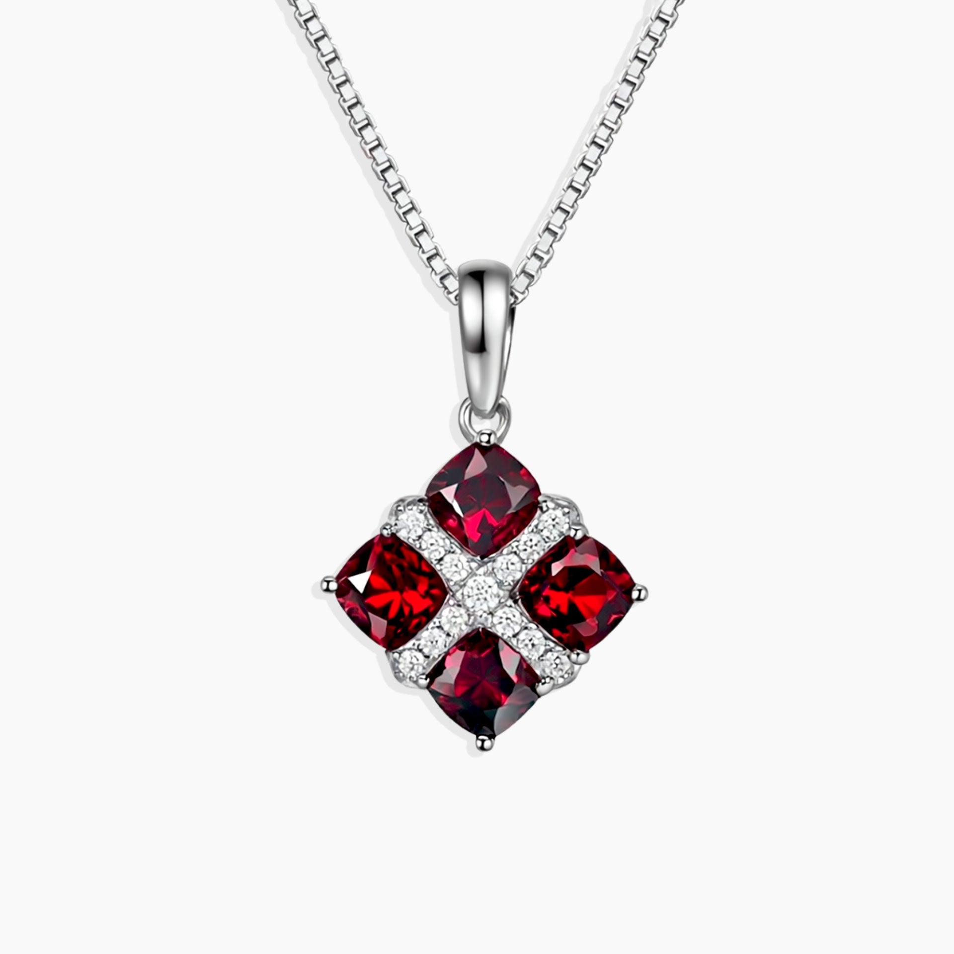 Created Ruby Cluster Pendant with four cushion-cut rubies set in rhodium-plated sterling silver on a 45 cm box chain.