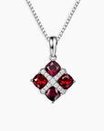 Created Ruby Cluster Pendant with four cushion-cut rubies set in rhodium-plated sterling silver on a 45 cm box chain.