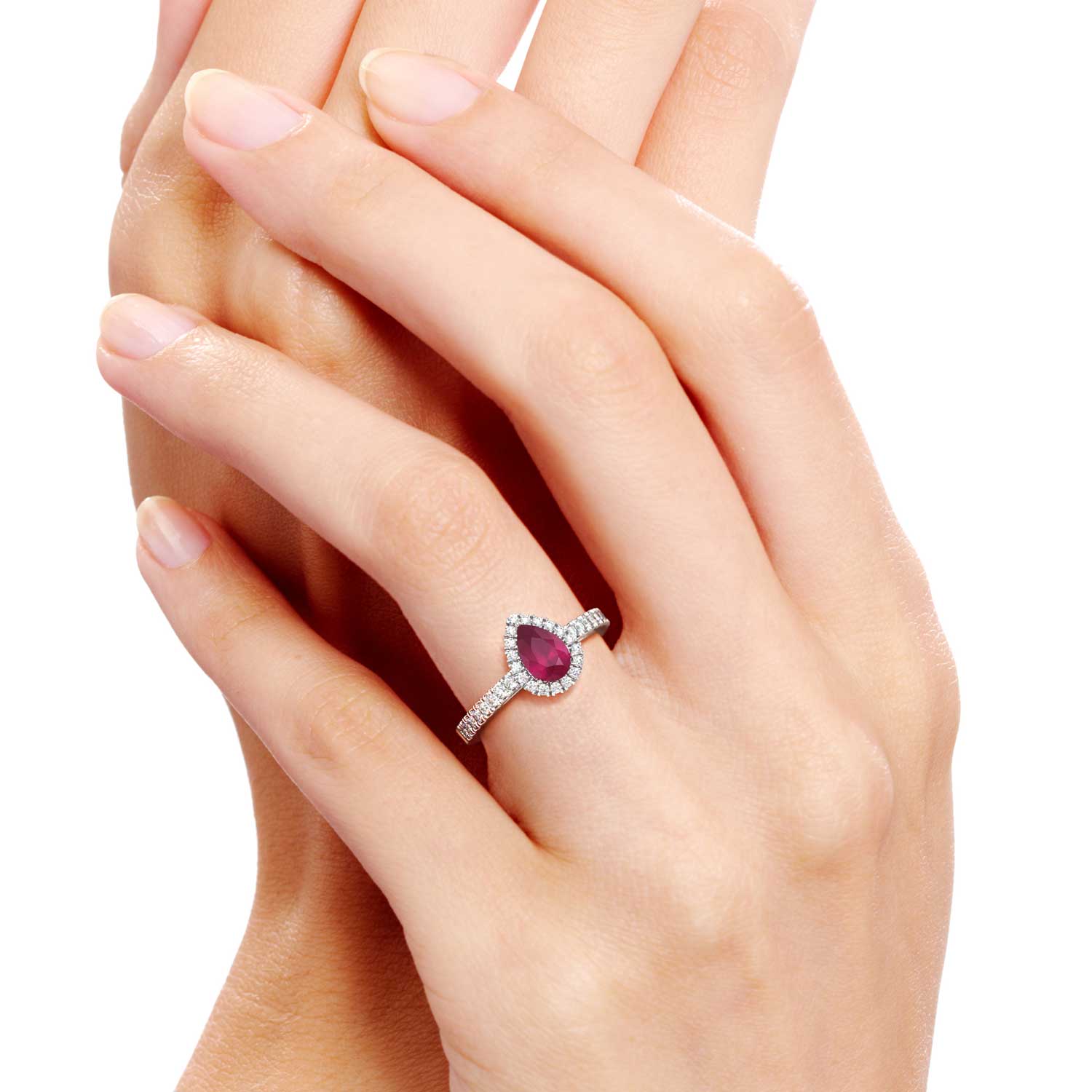 A radiant ruby pear-cut halo ring elegantly adorning a hand, exuding timeless charm and allure. The rich crimson hue of the ruby gemstone is accentuated by a shimmering halo of diamonds, creating a captivating and luxurious statement piece.