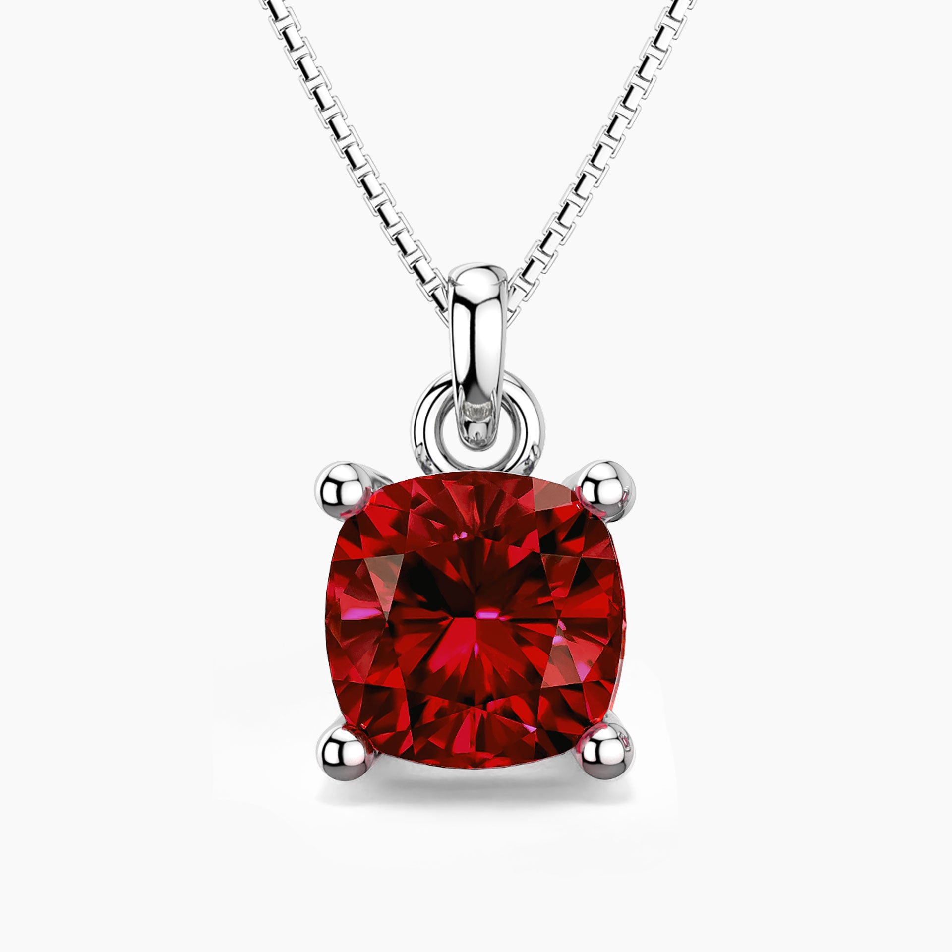 Cushion-cut ruby pendant in sterling silver with a box chain, showcasing a deep red gemstone in a classic four-prong setting.