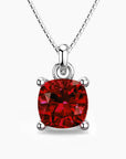 Cushion-cut ruby pendant in sterling silver with a box chain, showcasing a deep red gemstone in a classic four-prong setting.