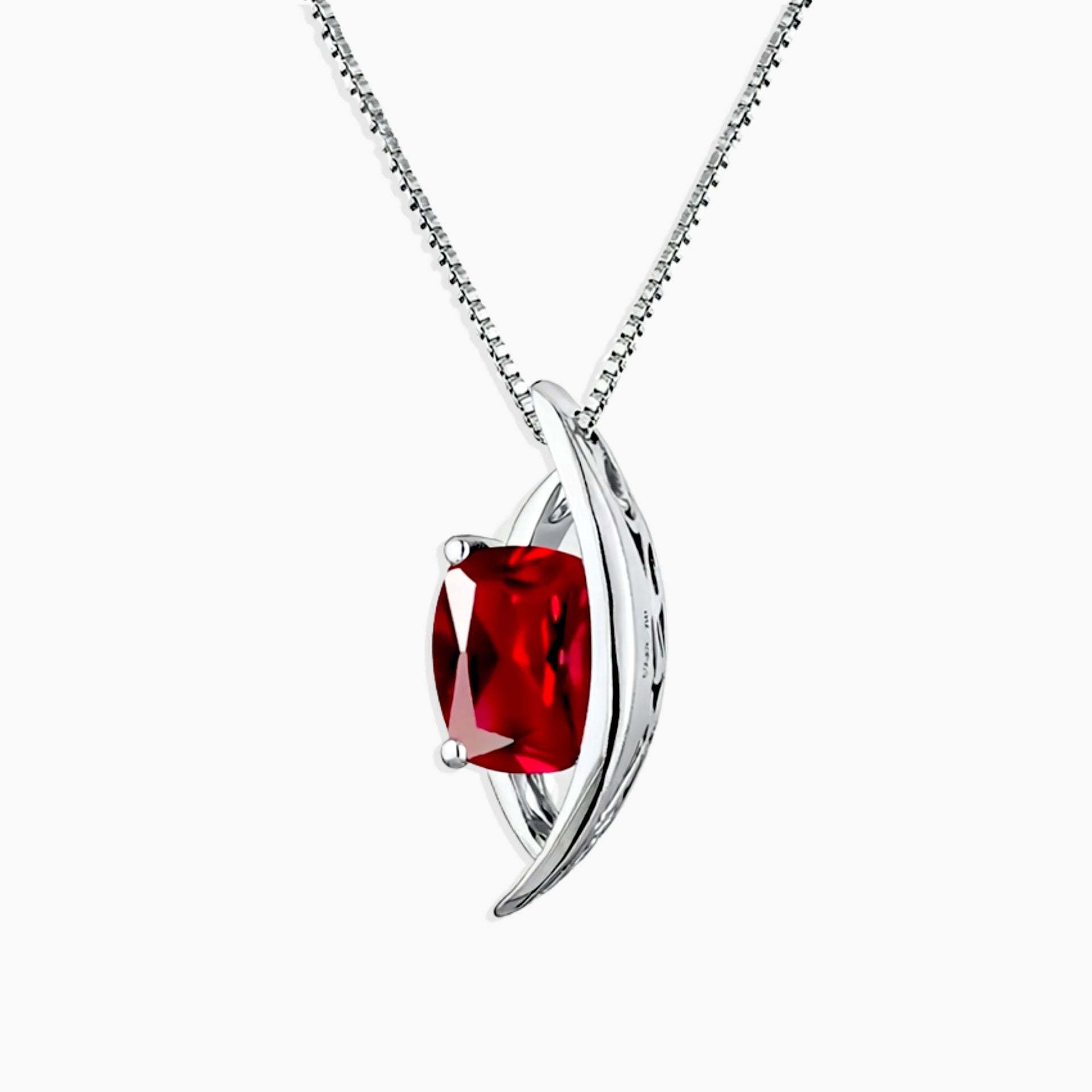 Silver necklace with a red gemstone pendant on a white background
