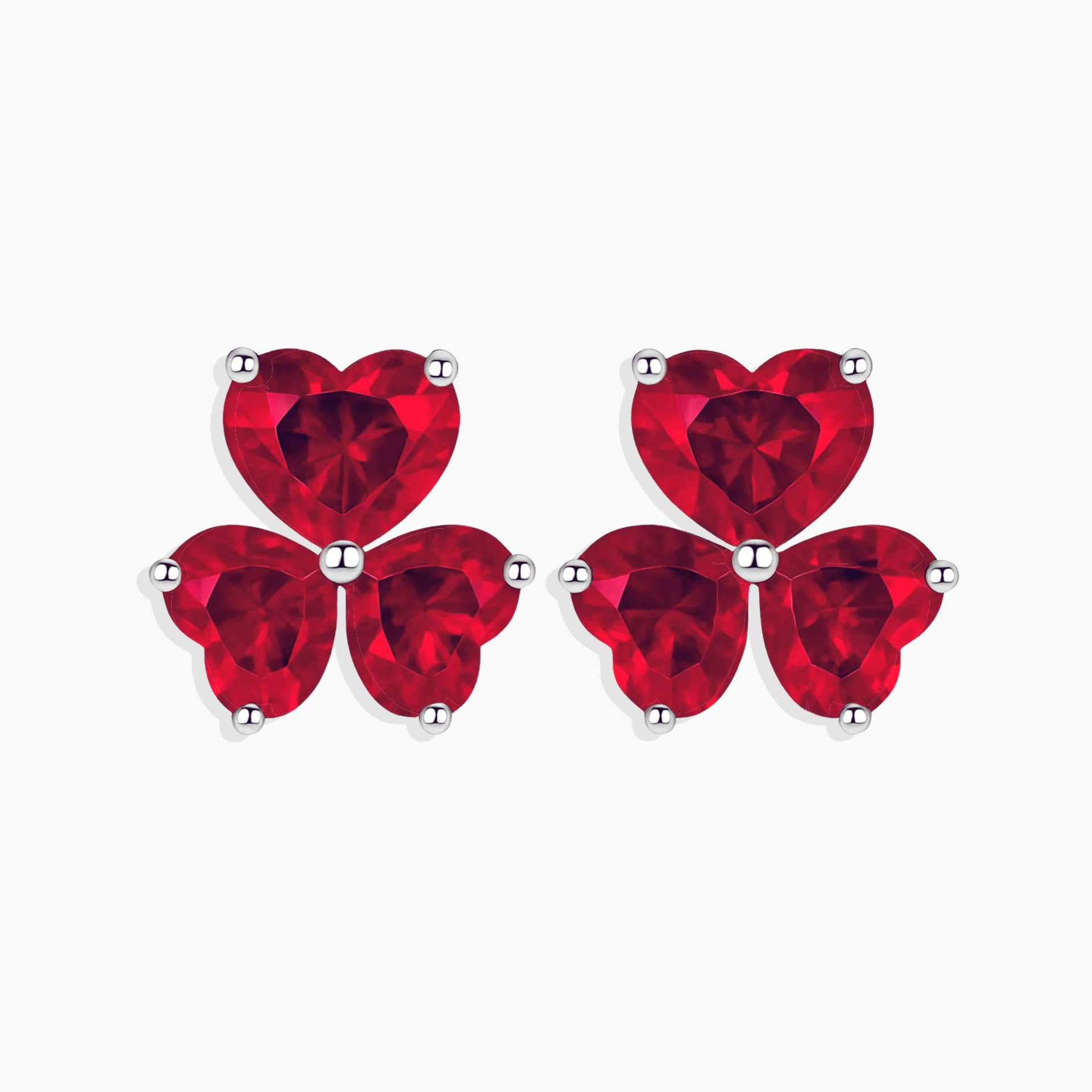 Pair of red heart-shaped stud earrings on a white background