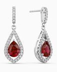 Teardrop-shaped earrings with red ruby  gemstones and diamond-like accents on a white background