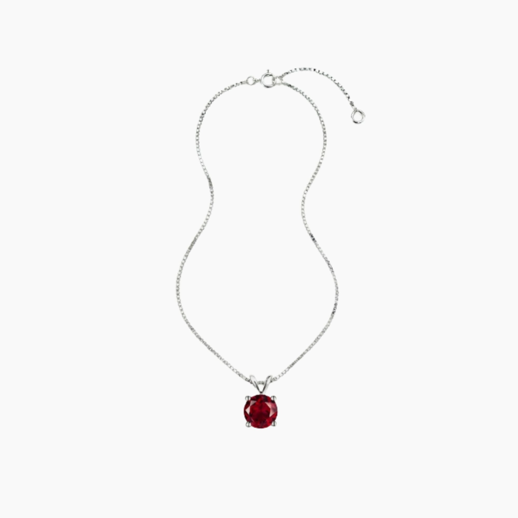 Silver necklace with a red pendant on a white background