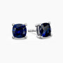Cushion-cut sapphire stud earrings in sterling silver, showcasing vivid blue stones in elegant four-prong mounts.