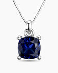 Cushion-cut sapphire pendant in sterling silver with a box chain, featuring a deep blue gemstone in a timeless four-prong setting.