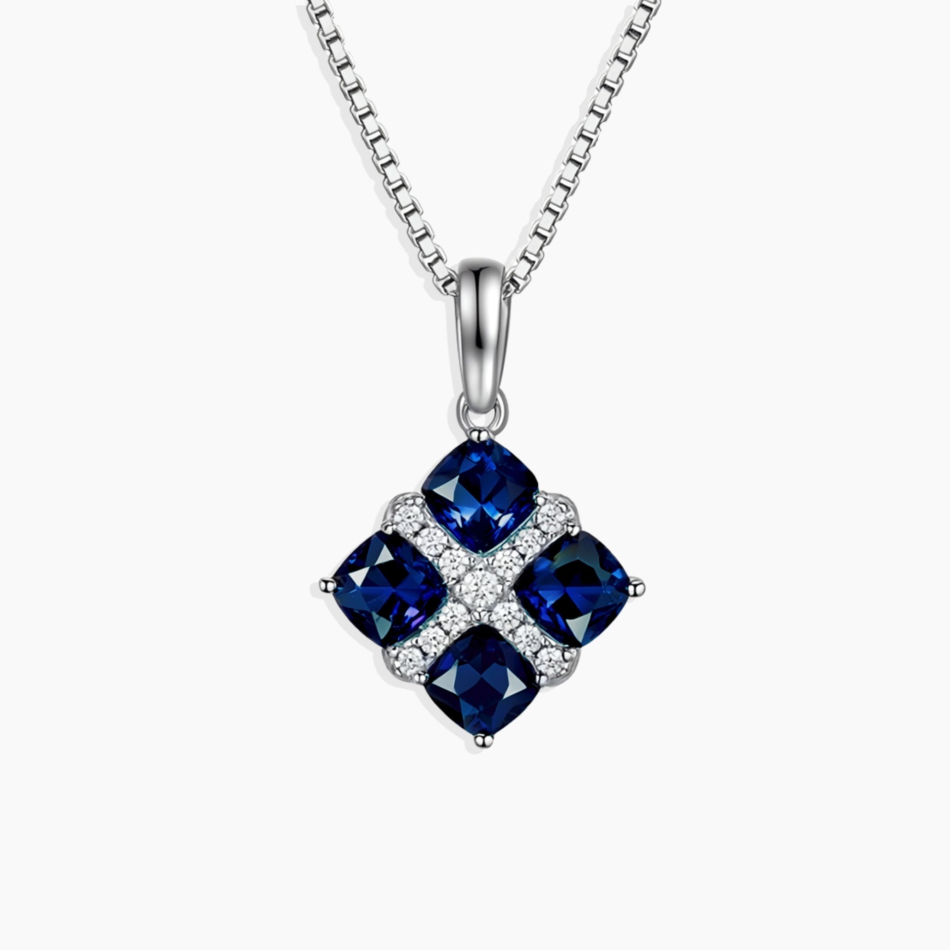 Sapphire Cluster Pendant with four cushion-cut natural sapphires set in rhodium-plated sterling silver on a 45 cm box chain.