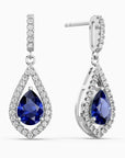 Teardrop-shaped sapphire earrings with diamond accents on a white background