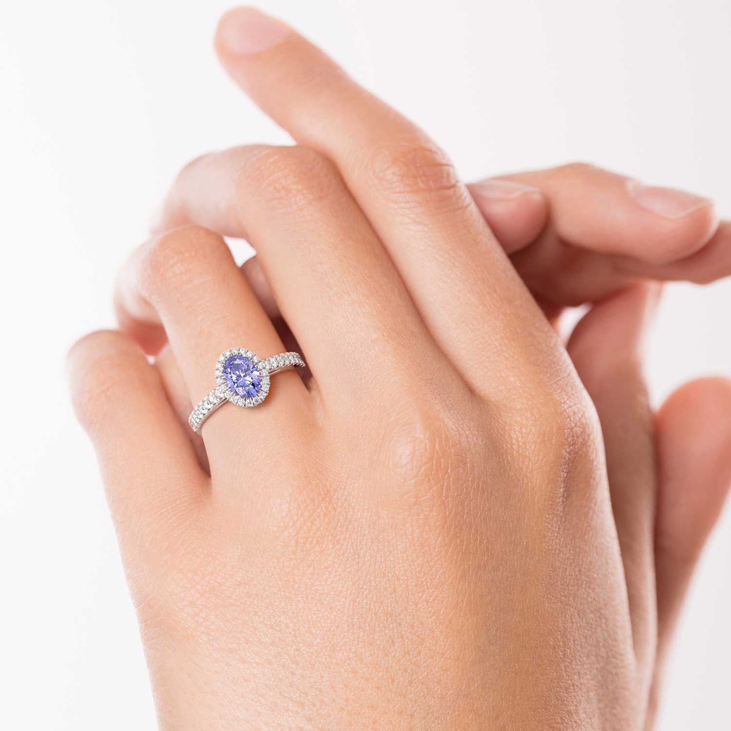 A mesmerizing tanzanite gemstone ring, showcasing its enchanting violet-blue hues and elegant design, elegantly displayed on a finger.