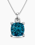 Cushion-cut blue topaz pendant in sterling silver with a box chain, featuring a brilliant sky-blue gemstone in a four-prong setting.