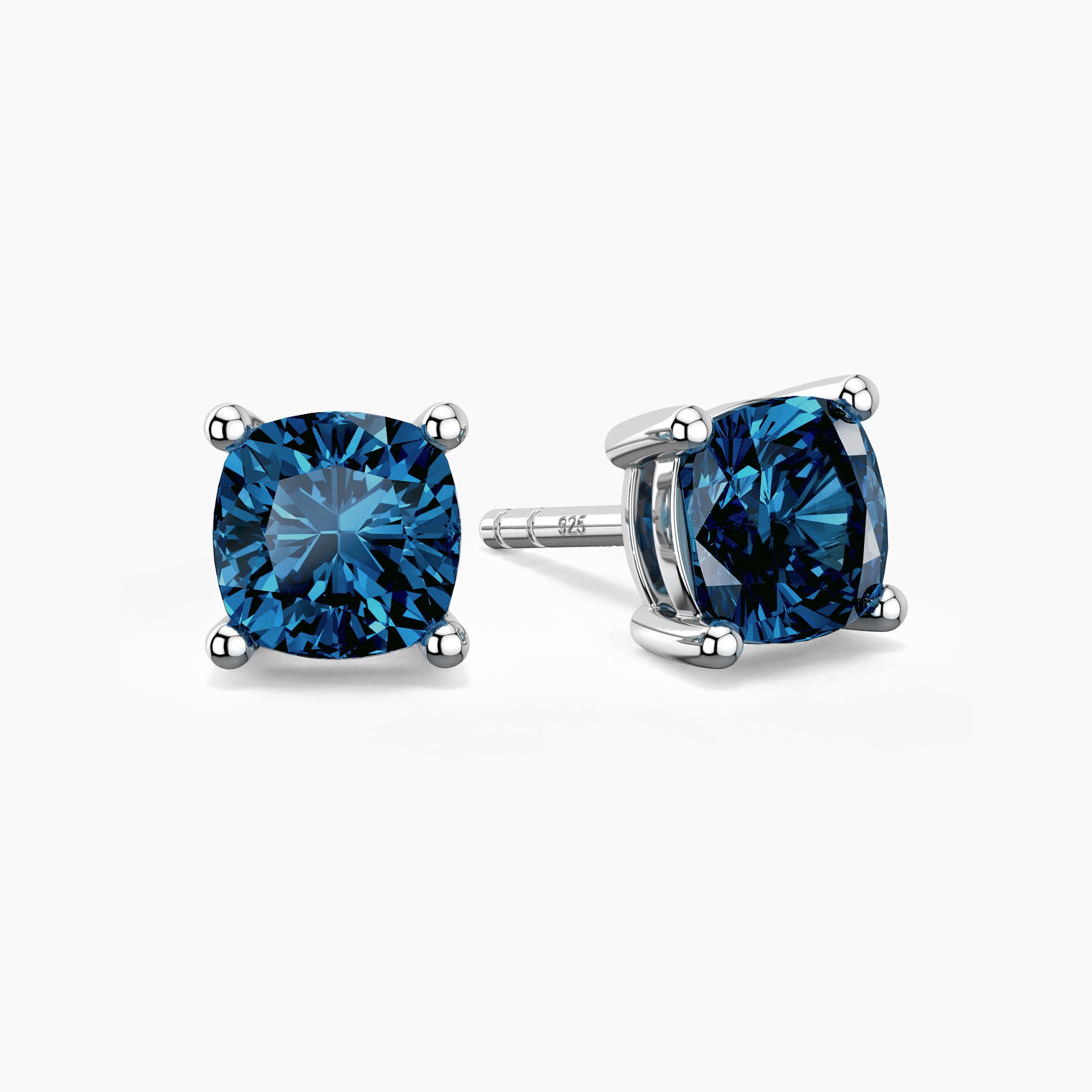 Cushion-cut blue topaz stud earrings in sterling silver, showcasing bright blue gemstones secured in elegant four-prong settings.