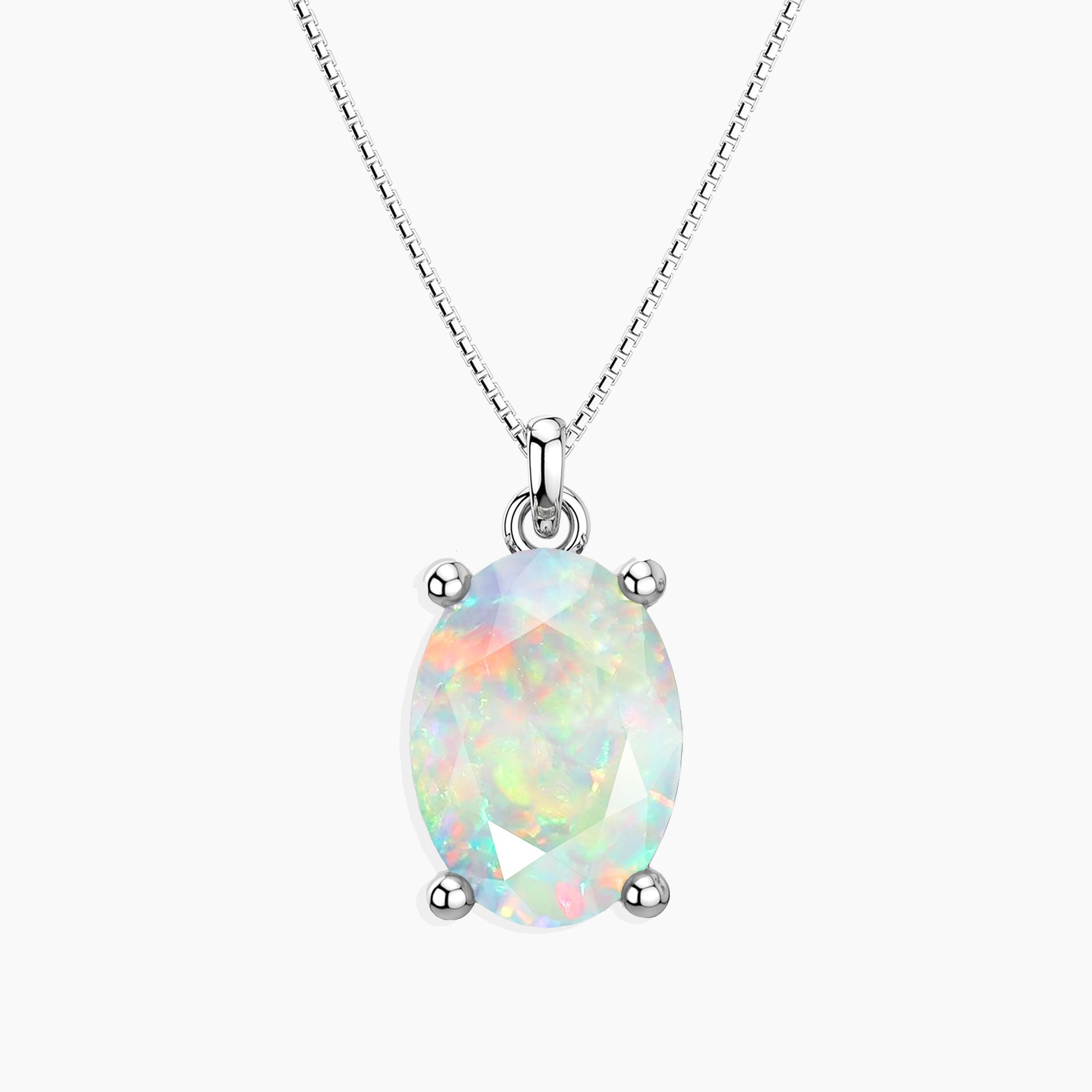 Oval-cut white opal pendant with iridescent rainbow hues in a four-prong silver setting, suspended from a fine silver chain, displayed on a light background.