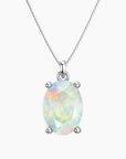 Oval-cut white opal pendant with iridescent rainbow hues in a four-prong silver setting, suspended from a fine silver chain, displayed on a light background.