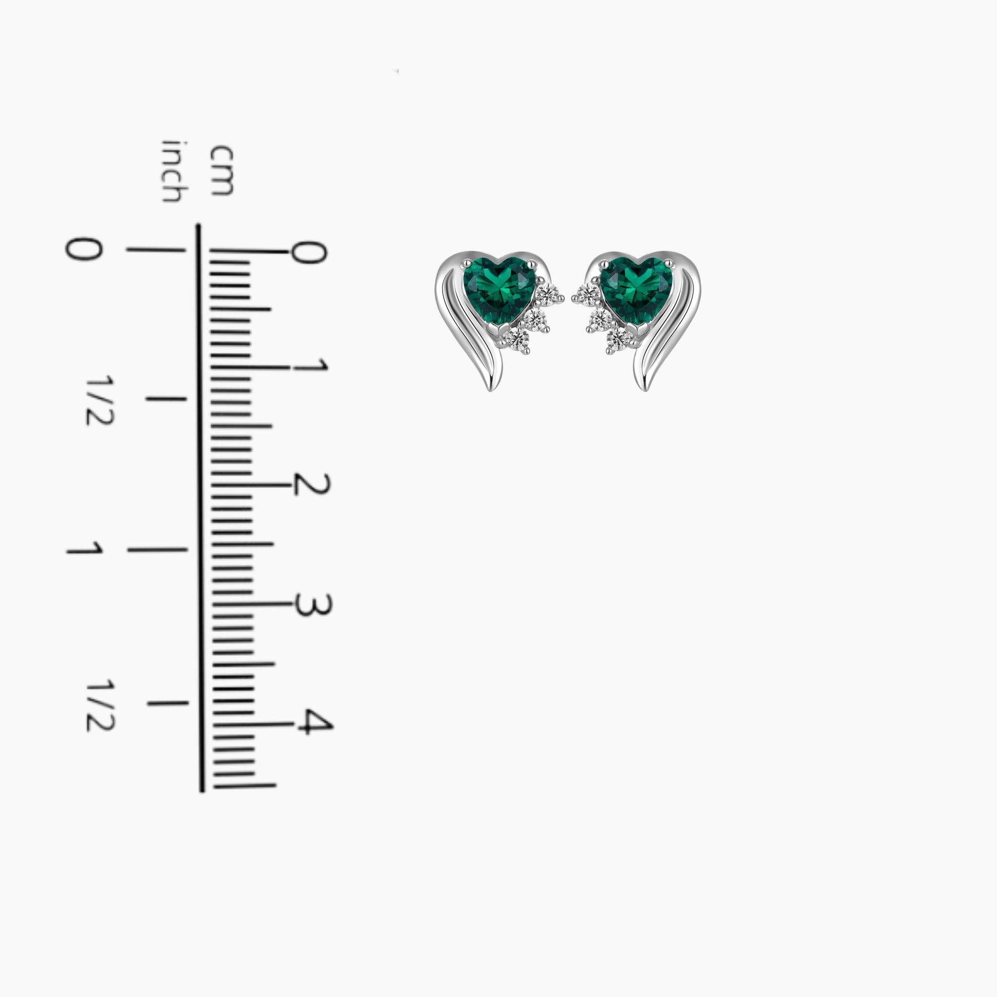 Silver emerald heart shape stud earrings next to scale for size comparison