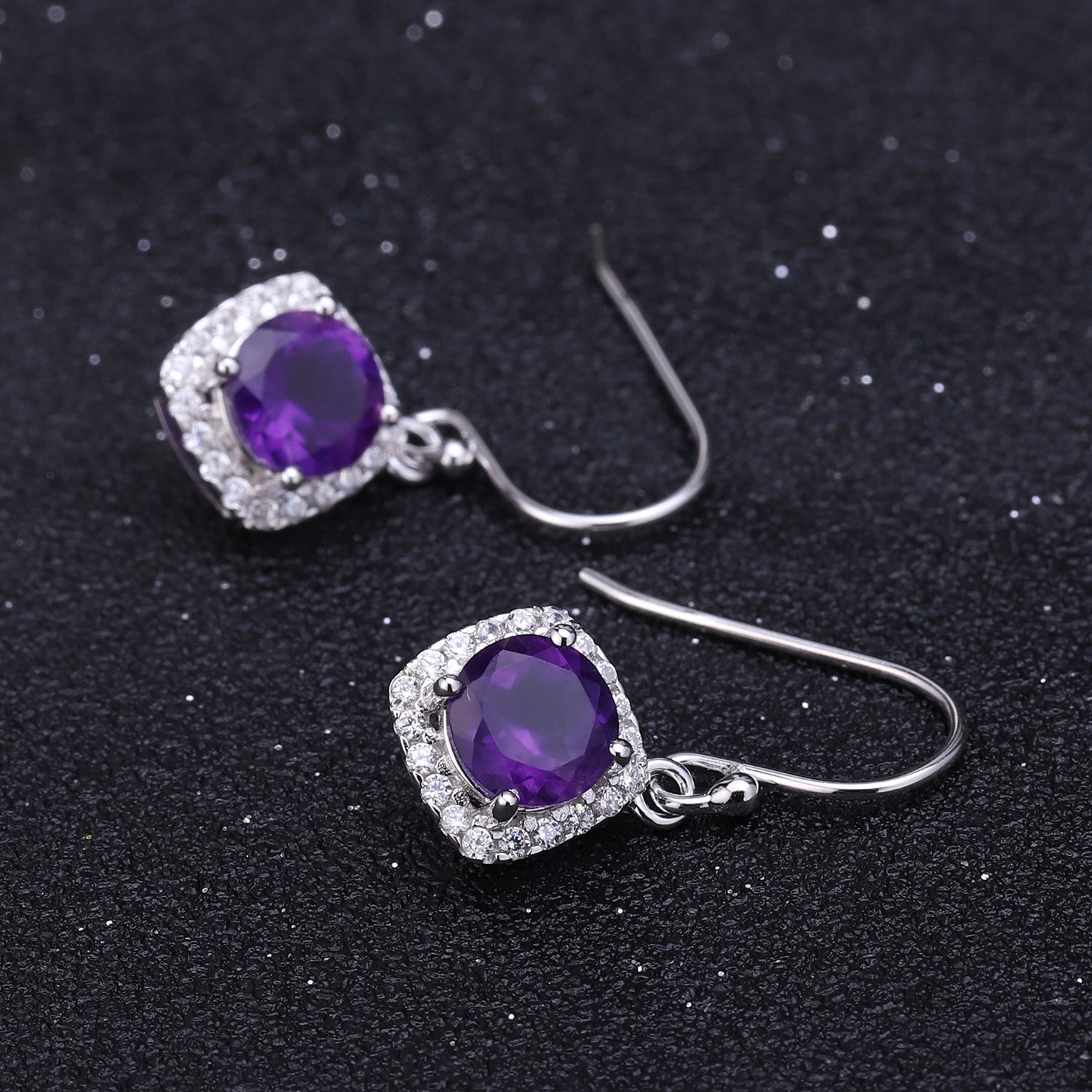 another angle of amethyst earrings on dark background