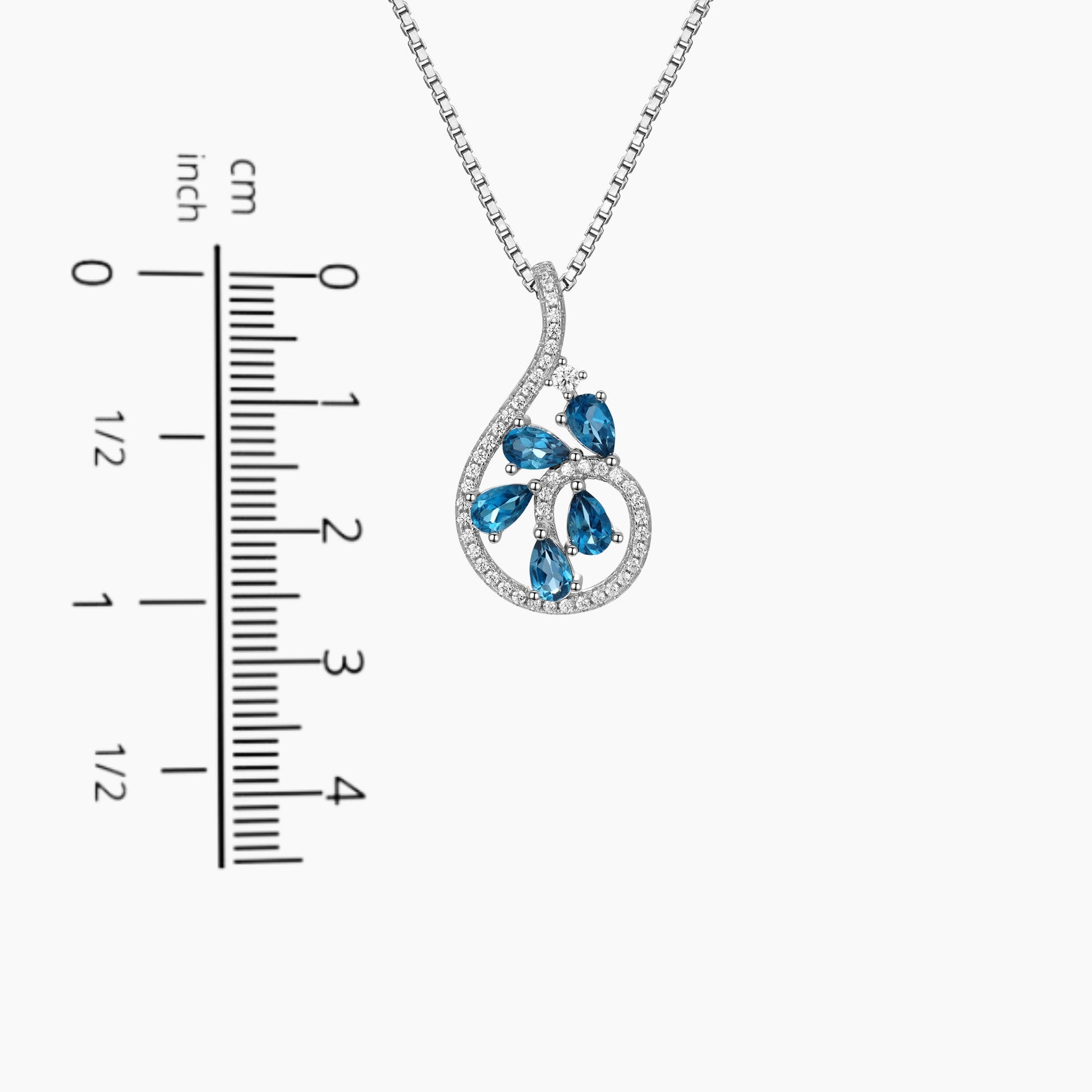 London Blue Topaz Dewdrop Pendant displayed next to a scale for size comparison