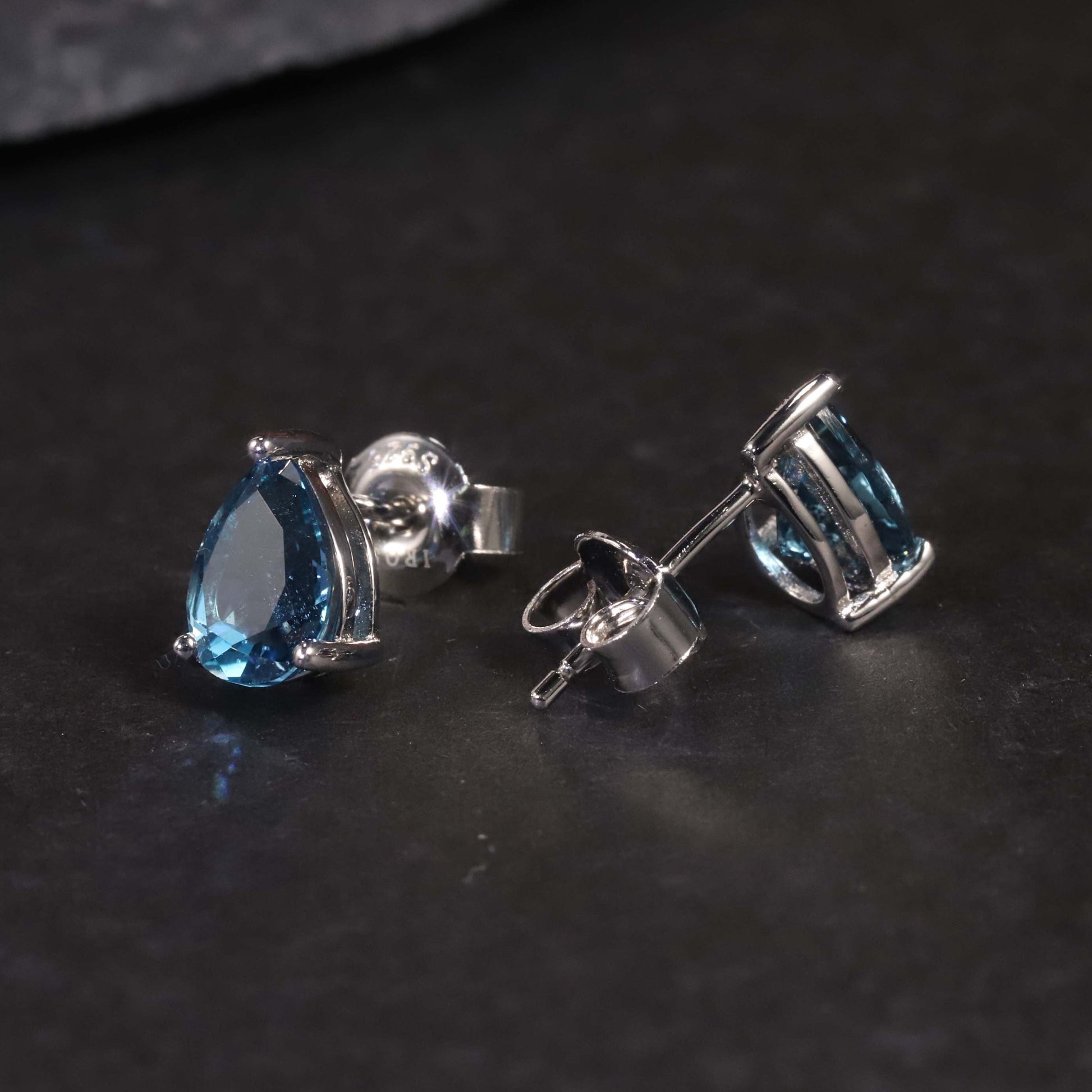 Side view of London Blue Topaz Pear Cut Stud Earrings