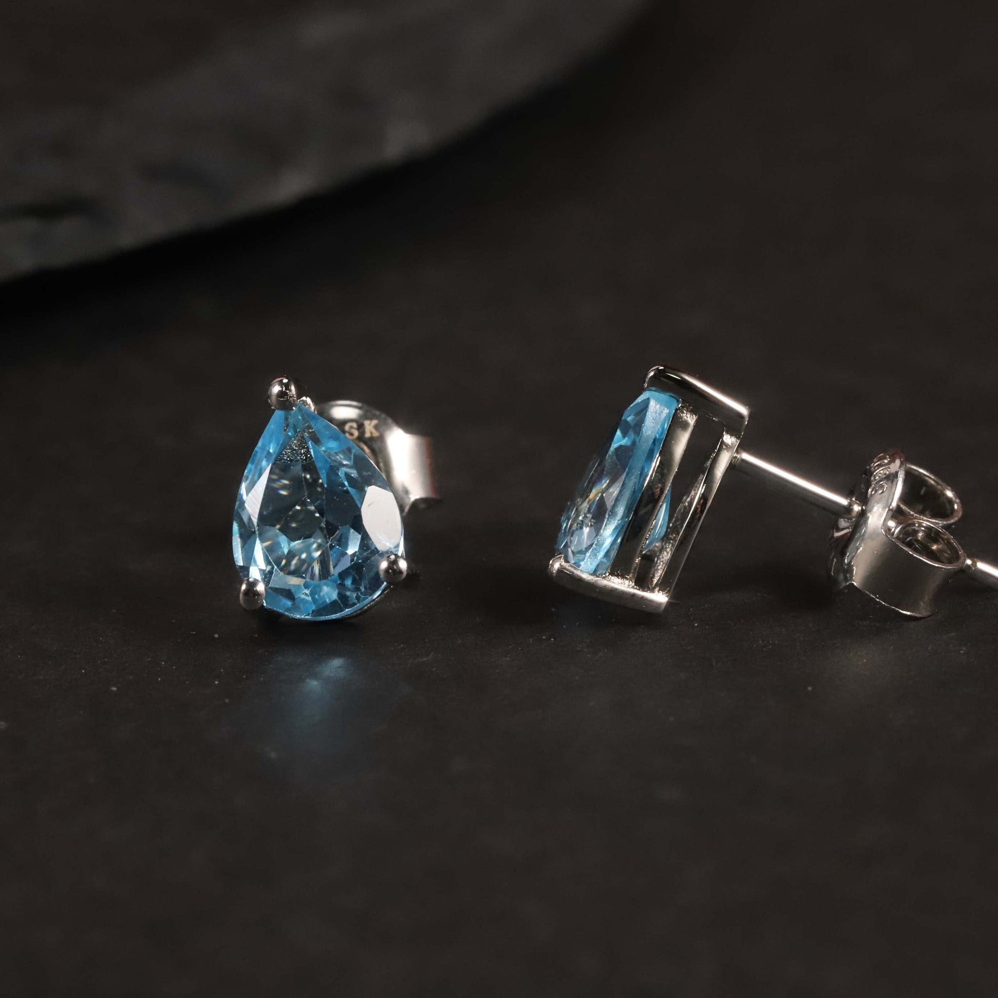 Side view of Swiss Blue Topaz Pear Stud Earrings