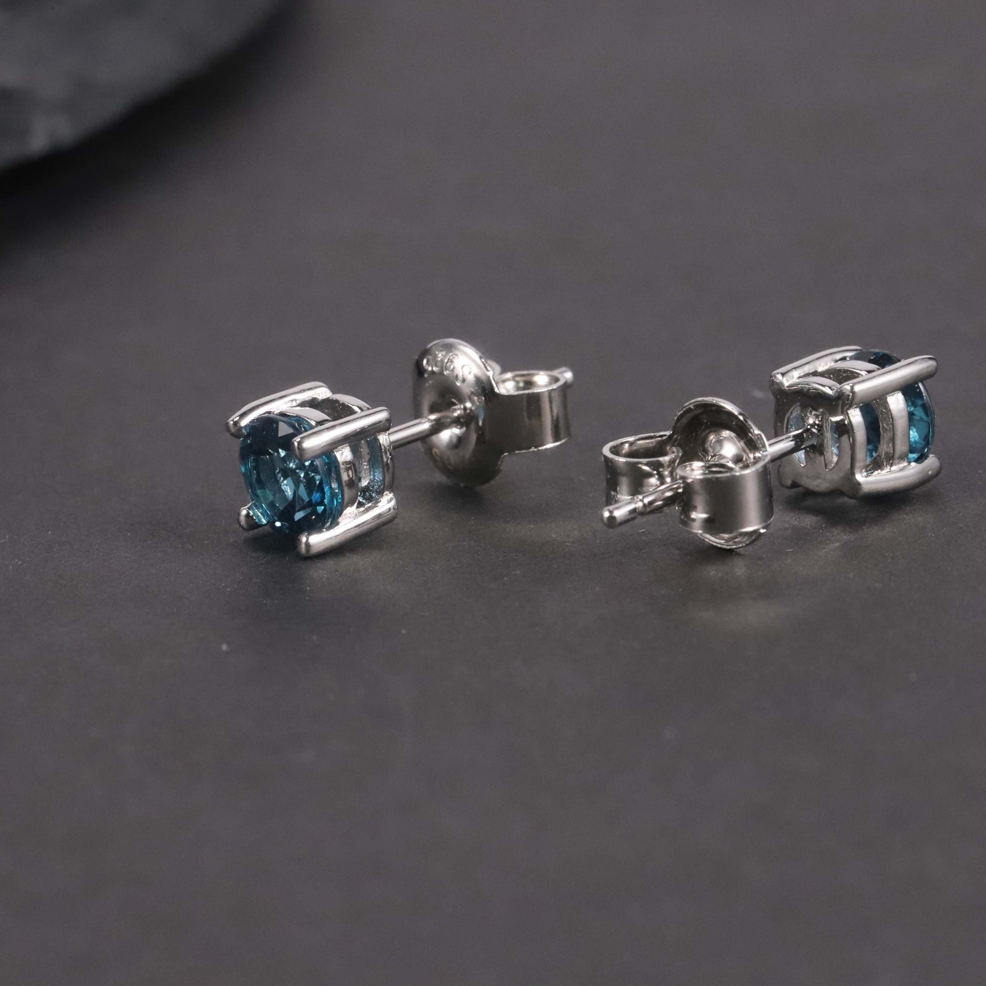 Side view of London Blue Topaz Round Cut Stud Earrings