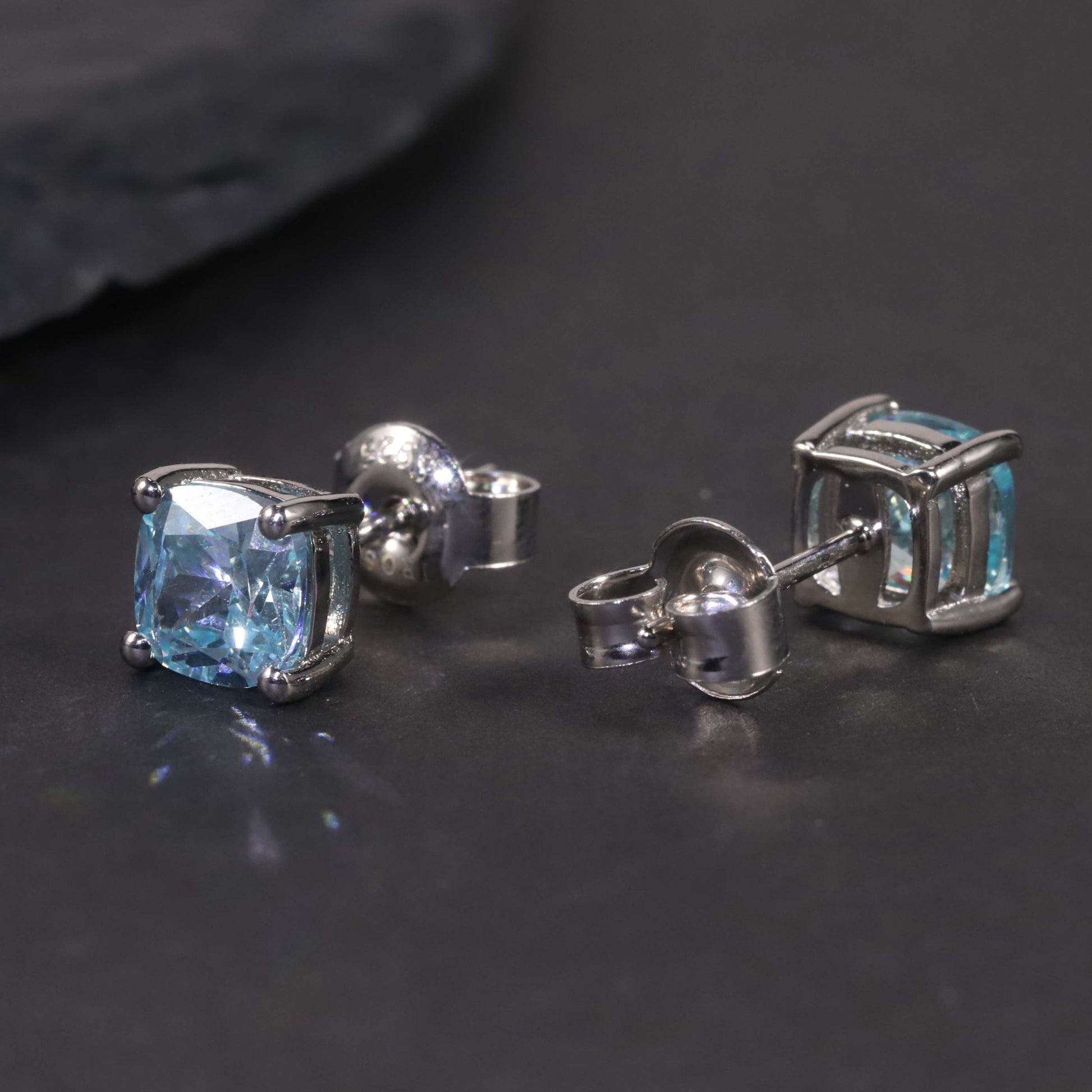 another view of swiss blue cushion cut earrings