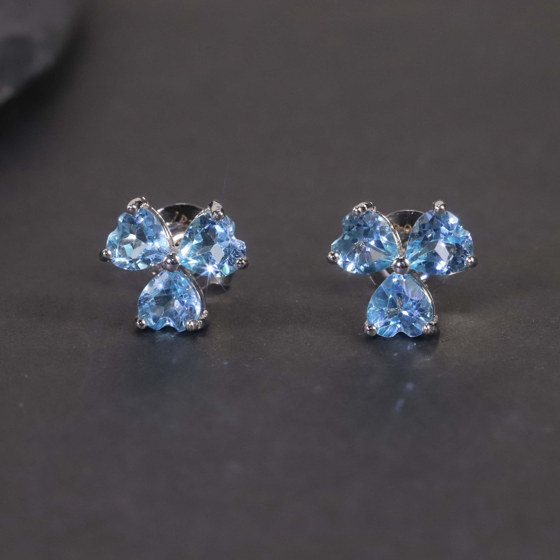view on dark background of Swiss Blue Flower Stud Earrings