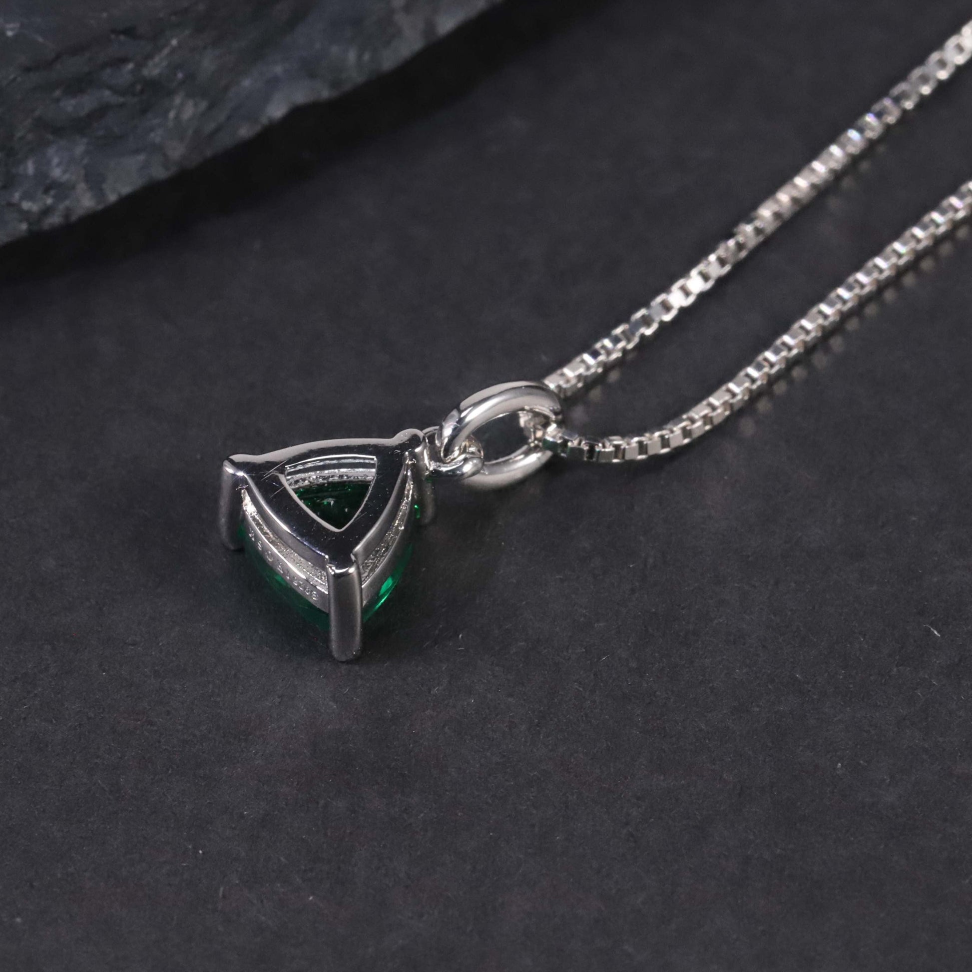 Back side photo of the trillion cut emerald pendant