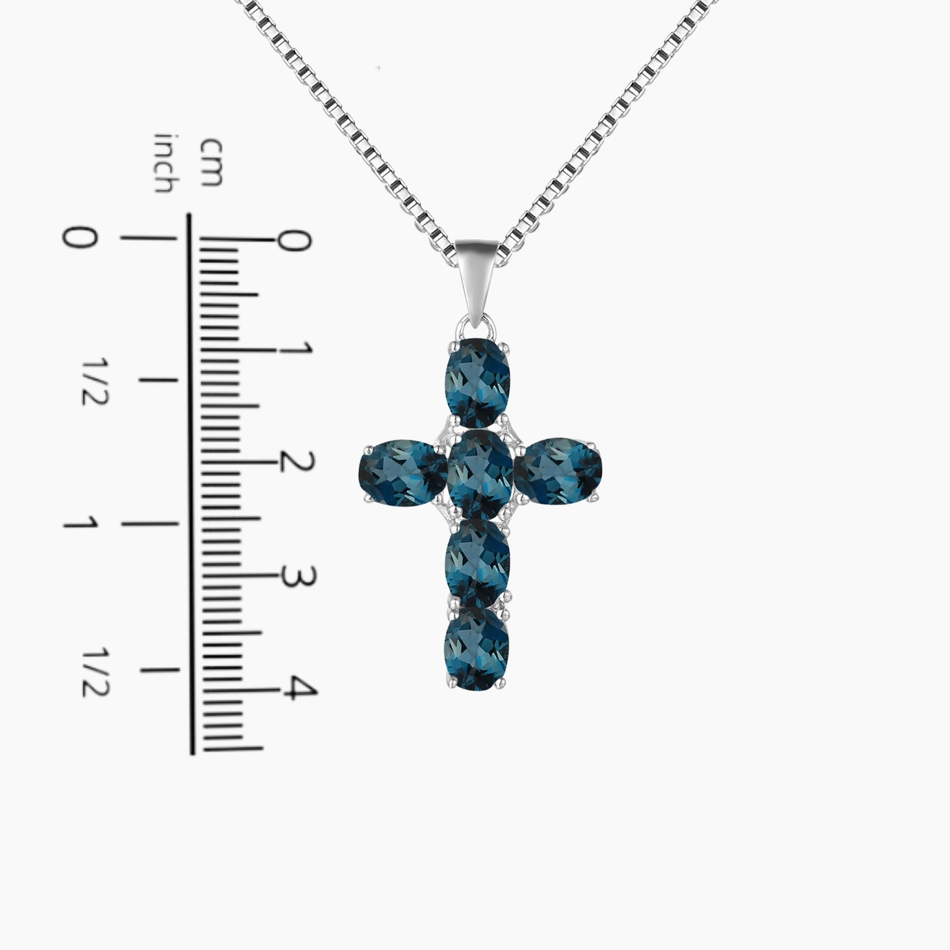 cross pendant next to a scale