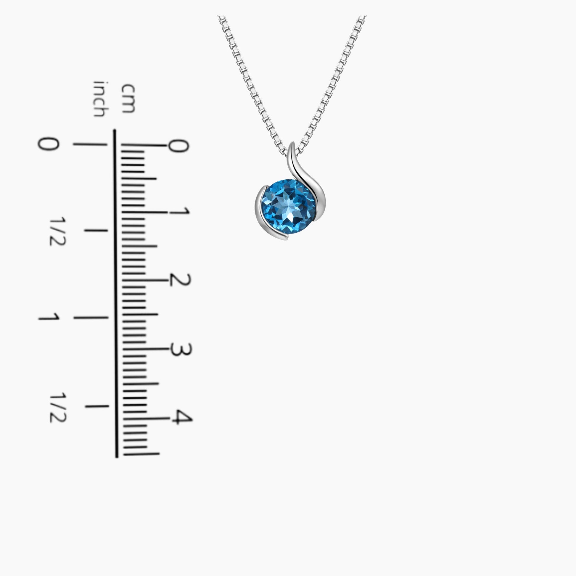 London Blue Topaz Monarch Pendant displayed next to a scale for size comparison