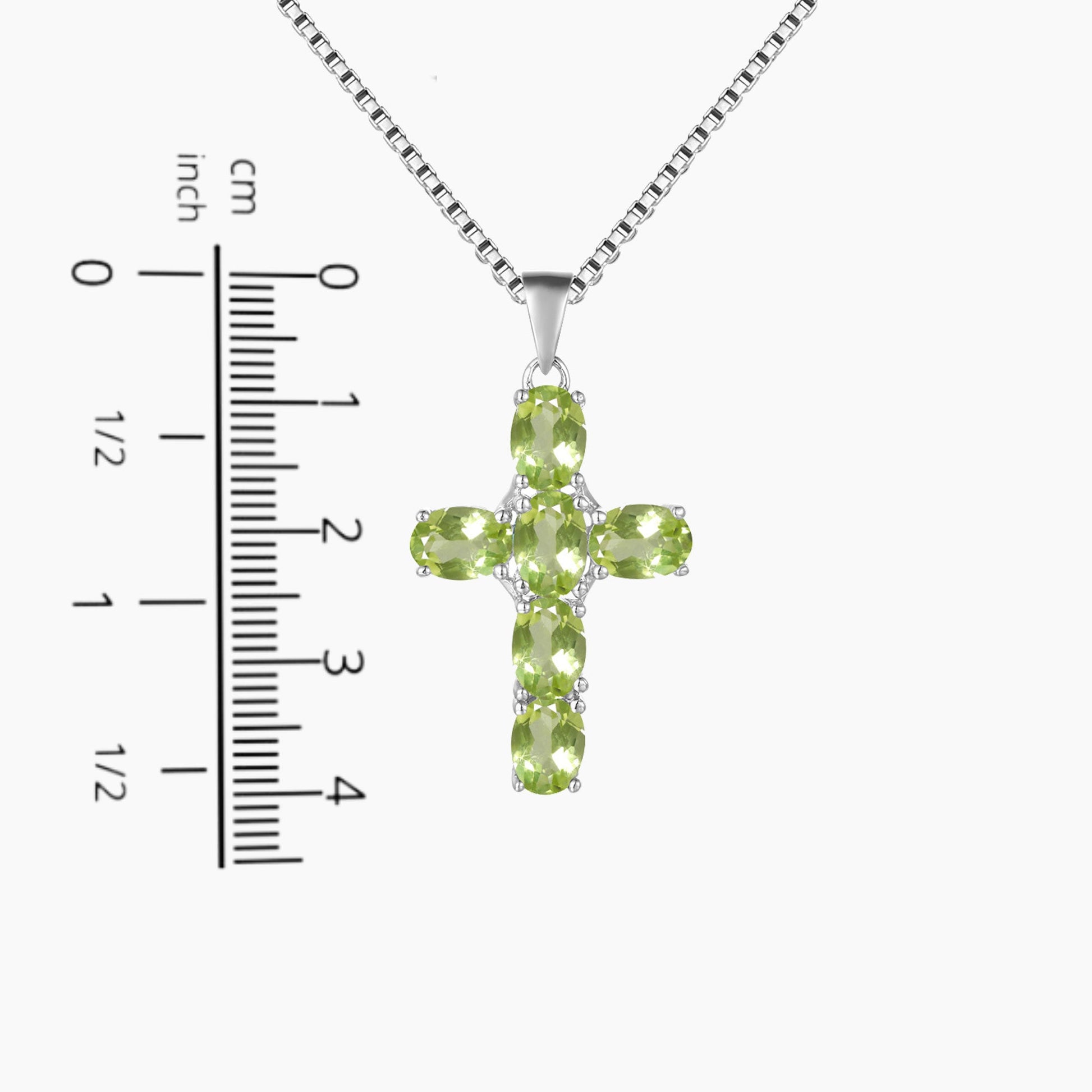 photo of peridot cross pendant on a scale